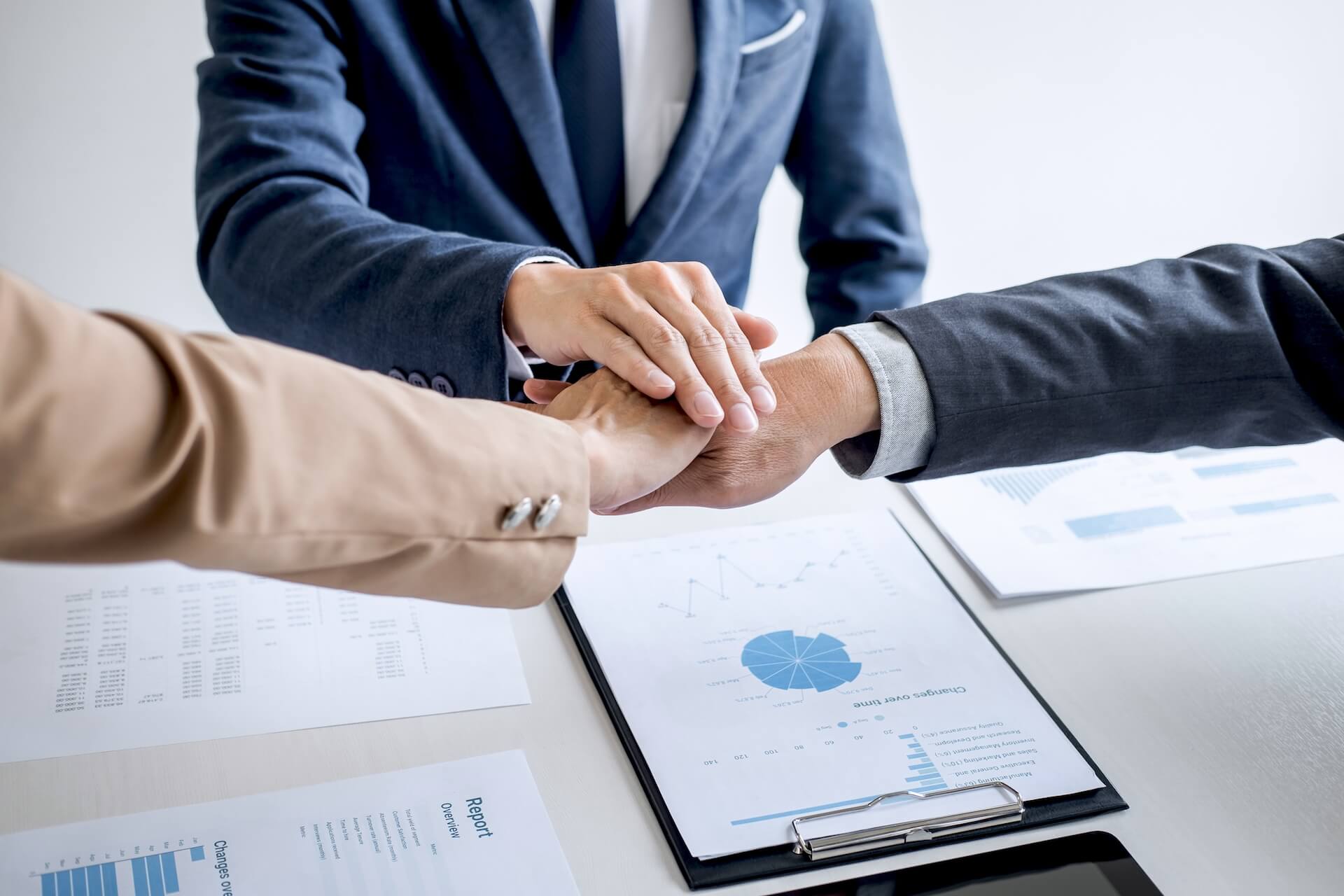 image-of-business-people-joining-and-putting-hands-together-during-their-meeting-connection-and_t20_7mWYj4.jpg