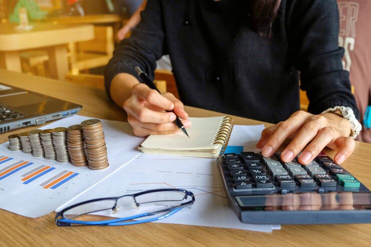 close up young asian female business owner making calculations savings finances co 57431 35